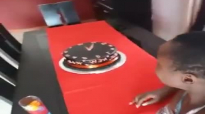 Kansiime Anne cuts the new years cake.mp4